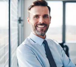 Portrait of successful businessman in modern office.png